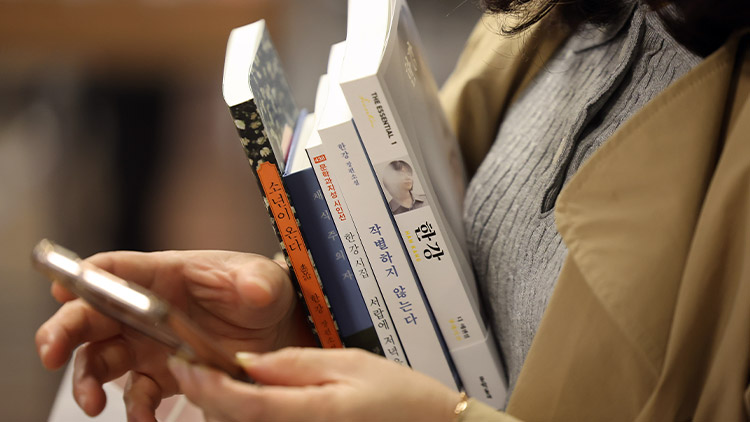 한 시민이 노벨문학상을 수상한 소설가 한강의 책을 구매하고 있다. /연합뉴스