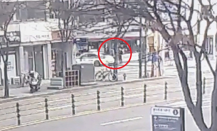 경찰이 A씨를 연행해 순찰차 쪽으로 데려가는 모습